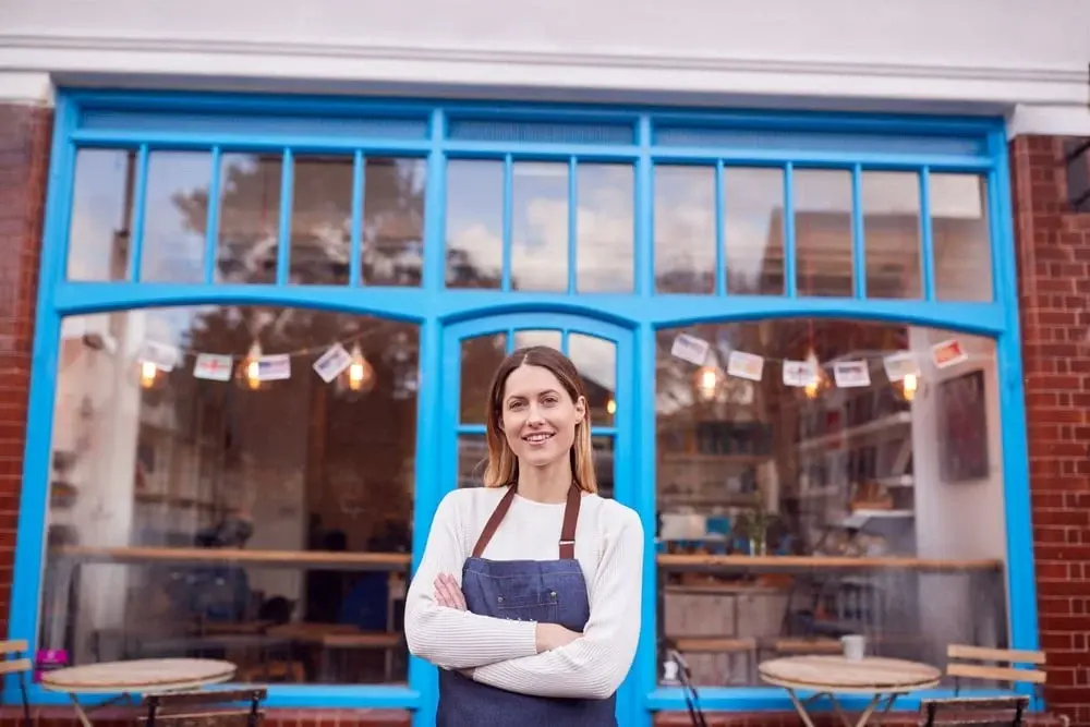 female business owner standing in front of store