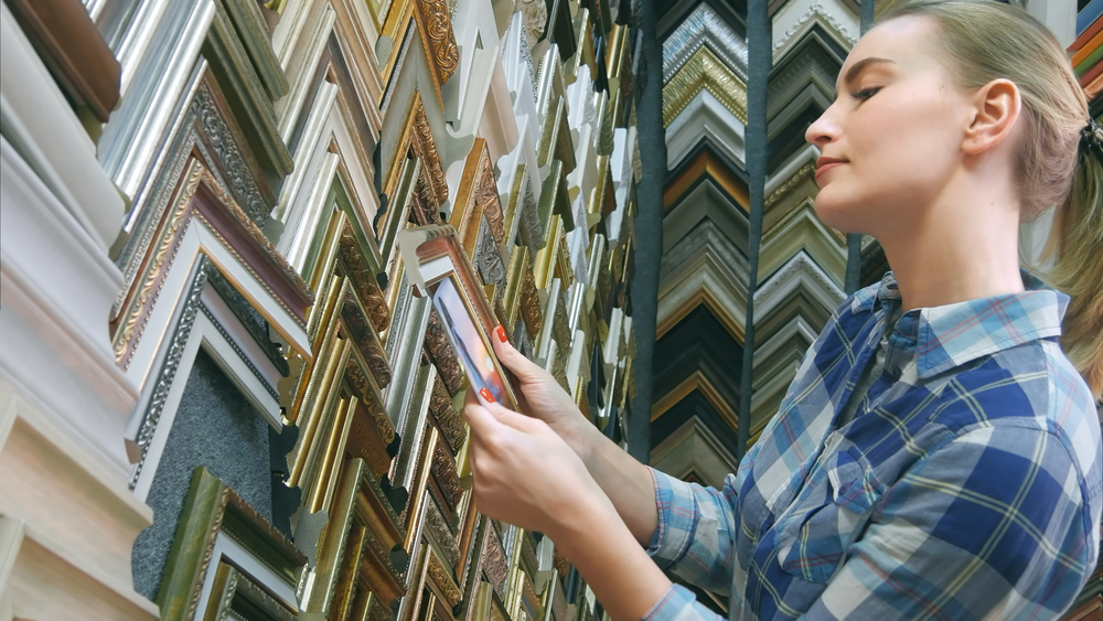 Woman looking for special frame in store