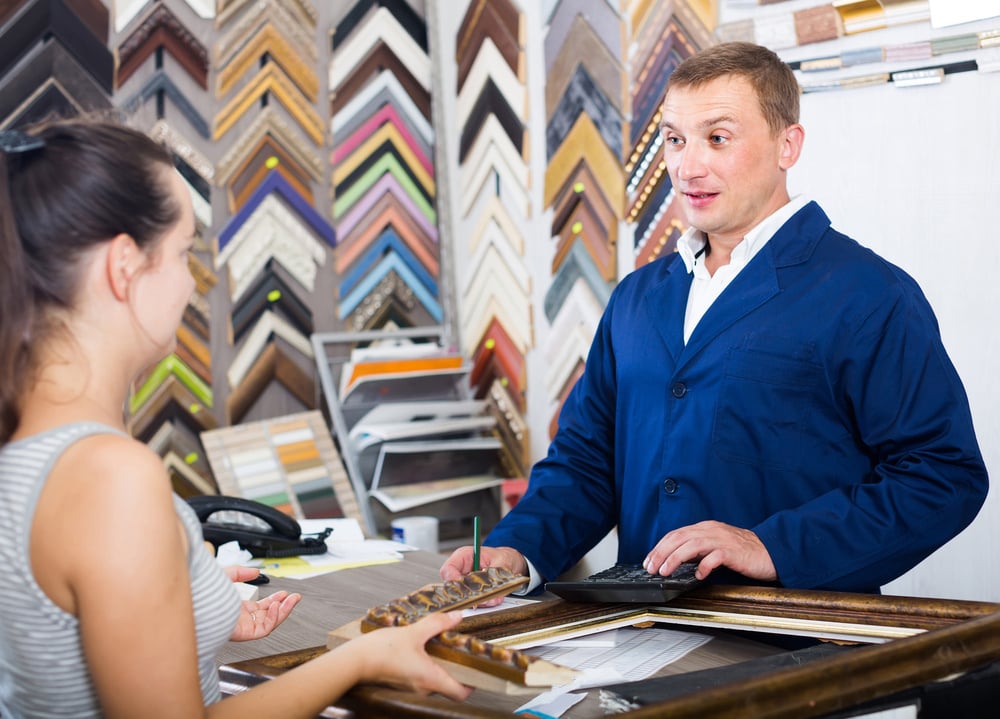 Man Buying Custom Frame at Store